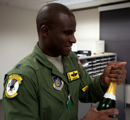 Lt. Col. Brian Hill, 96th Air Refueling Squadron commander, opens a bottle of champagne to celebrate with aircrew members after completing the squadron's first operational mission Dec. 14 at Joint Base Pearl Harbor-Hickam, Hawaii. During the mission, a 96th ARS KC-135 Stratotanker joined a KC-135 from the Iowa Air National Guard as part of a two-ship formation to refuel two B-52 Stratofortresses on the way to Guam. (U.S. Air Force photo/Staff Sgt. Nathan Allen)