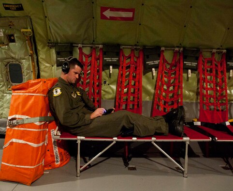 Capt. Clifton Norvell, 96th Air Refueling Squadron medical element, passes the time on the 96th ARS's first operational mission Dec. 14 at Joint Base Pearl Harbor-Hickam, Hawaii. During the mission, a 96th ARS KC-135 Stratotanker joined a KC-135 from the Iowa Air National Guard as part of a two-ship formation to refuel two B-52 Stratofortresses on the way to Guam. (U.S. Air Force photo/Staff Sgt. Nathan Allen)