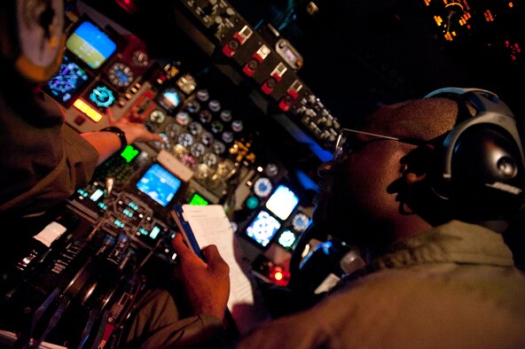 Lt. Col. Brian Hill, 96th Air Refueling Squadron commander and aircraft commander for the squadron's first operational refueling mission, completes a pre-flight checklist Dec. 14 at Joint Base Pearl Harbor-Hickam, Hawaii. During the mission, a 96th ARS KC-135 Stratotanker joined a KC-135 from the Iowa Air National Guard as part of a two-ship formation to refuel two B-52 Stratofortresses on the way to Guam. (U.S. Air Force photo/Staff Sgt. Nathan Allen)