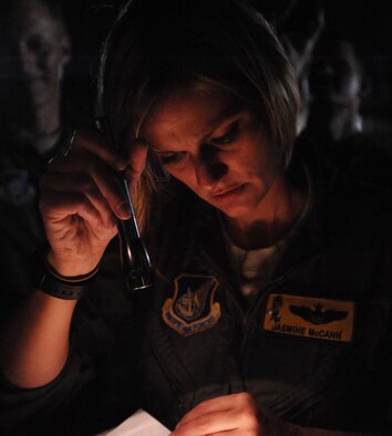 Capt. Jasmine McCann, 96th Air Refueling Squadron pilot, reviews maintenance documents with KC-135 Stratotanker crew chiefs from the Hawaii Air National Guard Dec. 14 at Joint Base Pearl Harbor-Hickam, Hawaii. During the mission, a 96th ARS KC-135 Stratotanker joined a KC-135 from the Iowa Air National Guard as part of a two-ship formation to refuel two B-52 Stratofortresses on the way to Guam. (U.S. Air Force photo/Staff Sgt. Nathan Allen)