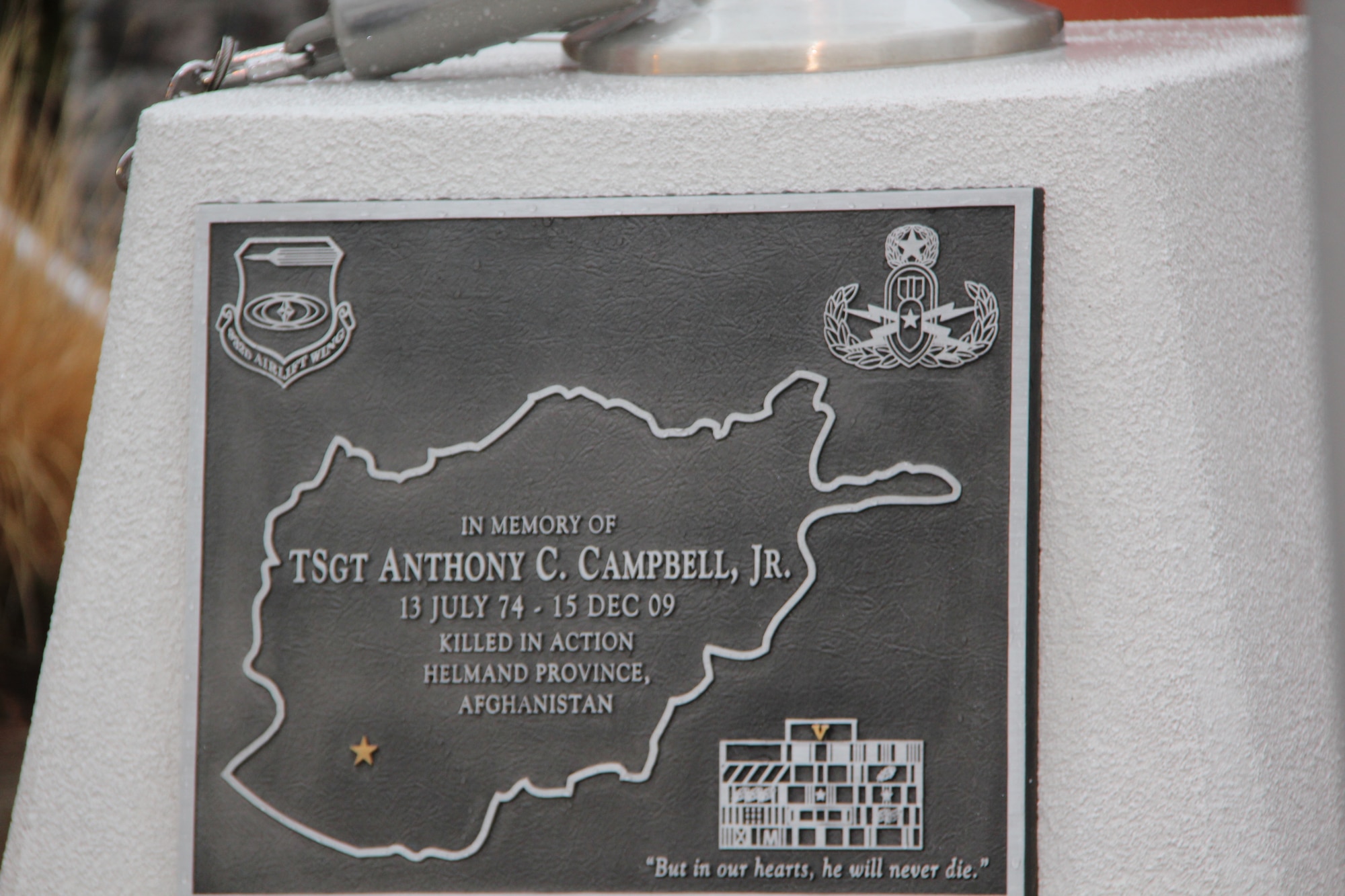 Scott Air Force Base, Ill.--The engraved plaque was dedicated to Tech. Sgt. Anthony Campbell who was killed during combat operations while deployed to Afghanistan. The plaque is mounted on the flag pole base in front of the 932nd Airlift Wing headquarters building.  Sergeant Campbell was an explosive ordnance disposal specialist who was assigned to the 932nd Civil Engineer Squadron. The ceremony was held at the December unit training assembly. (Courtesy photo/932nd AW Public Affairs)  