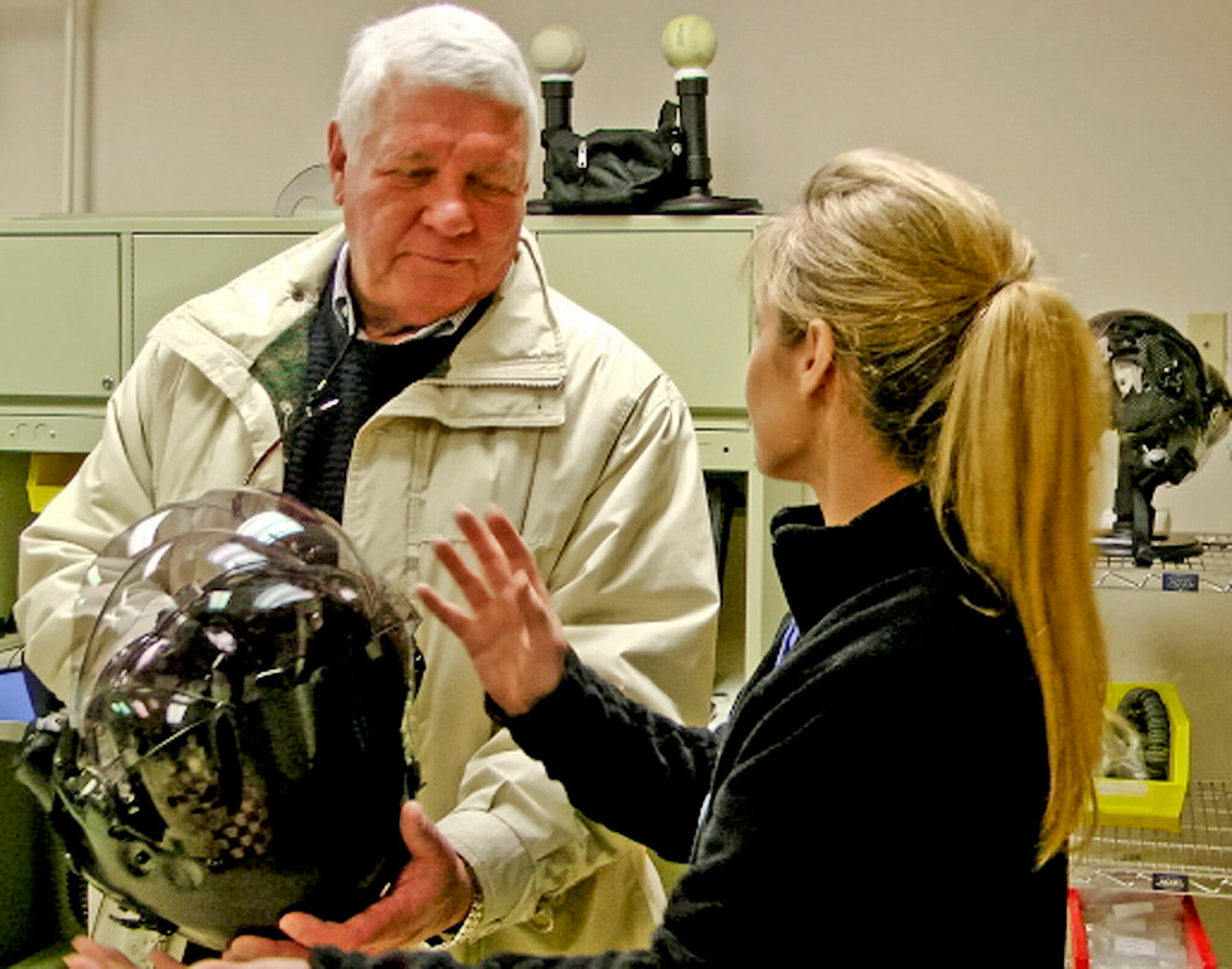 Commissioner Bill Roberts gets a briefing on the new helmet used for the Joint Strike Fighter by Laurie Albarino, Lockheed Martin, during a tour of the 33rd Fighter Wing Dec. 14.  Photo by Kathy Newby.