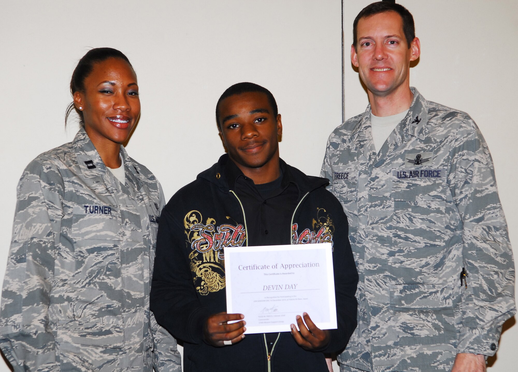 YOKOTA AIR BASE, Japan -- Devin Day, a student at Yokota High School, receives an award for completing a job shadow course during a luncheon here, Dec. 14. Students followed professionals in the job of their interest for 2.5 hours to get an idea of what the job is like. (U.S. Air Force photos/Airman 1st Class Lynsie Nichols)