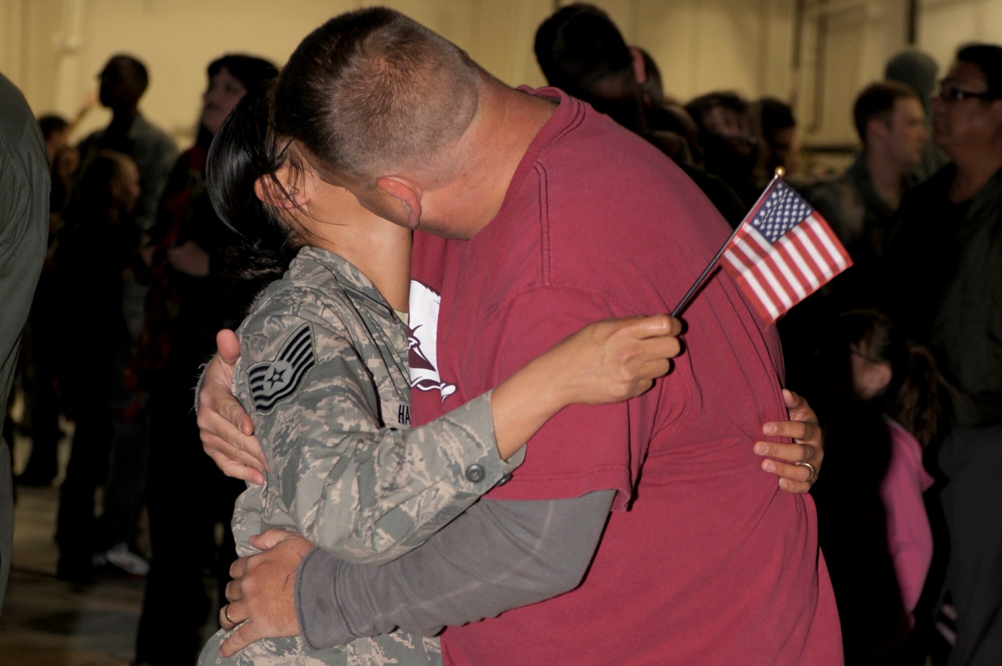 U.S. Air Force Tech. Sgt. Lorelaine Hale, 27th Special Operations Force Support Squadron, kisses her husband Ray Hale outside hanger 196 Dec. 10. Hale?s family waited with many others in hanger 196 to welcome back their Airmen from deployment. (U.S. Air Force photo by Airman Ericka Engblom)  
