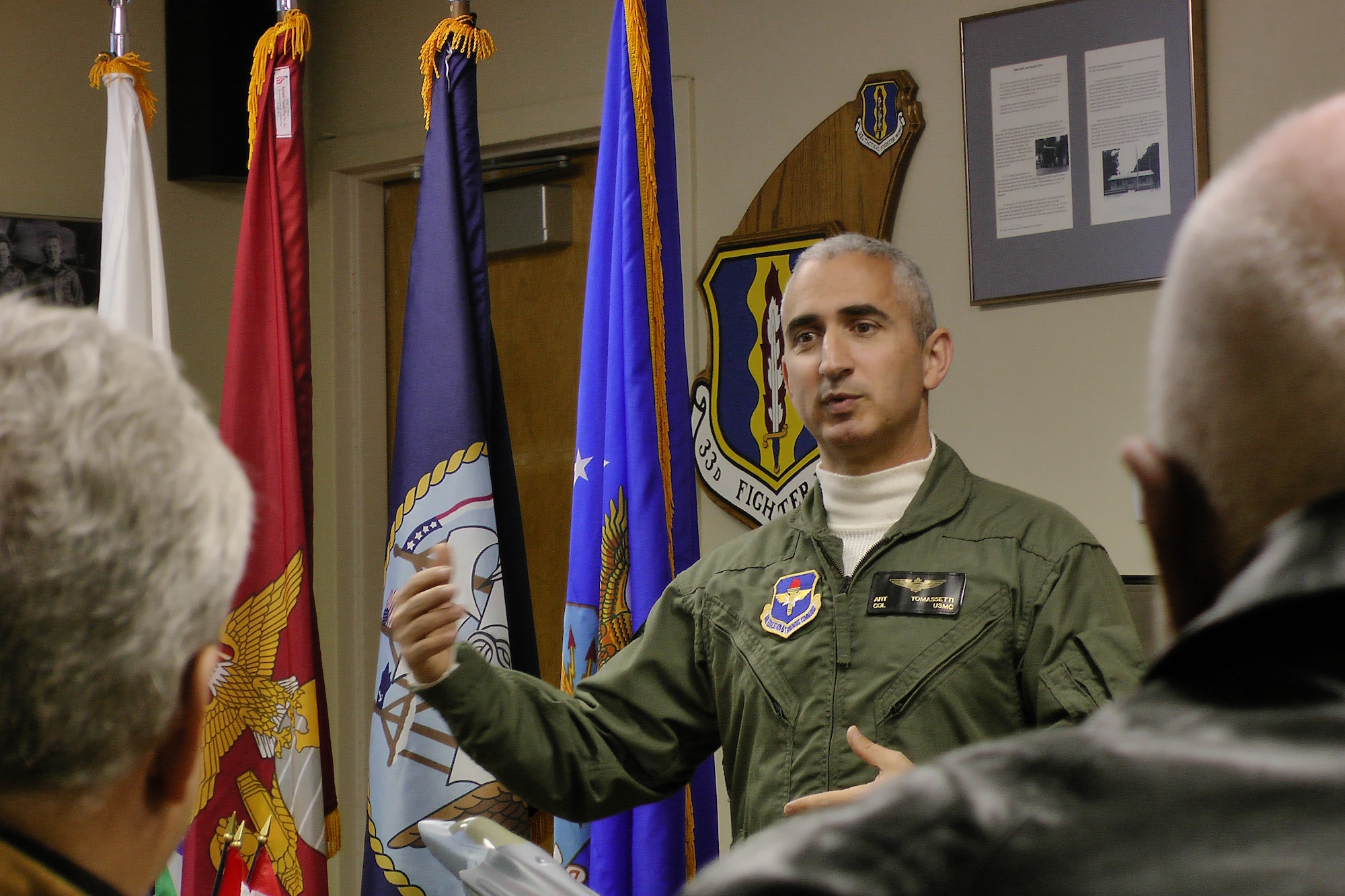Marine Col. Art Tomessetti, 33rd Fighter Wing vice commander, explains how his team is preparing to train future pilots and maintainer of the F-35 to Okaloosa County commissioners during their tour here Dec. 14. (Courtesy photo by Kathy Newby) 
