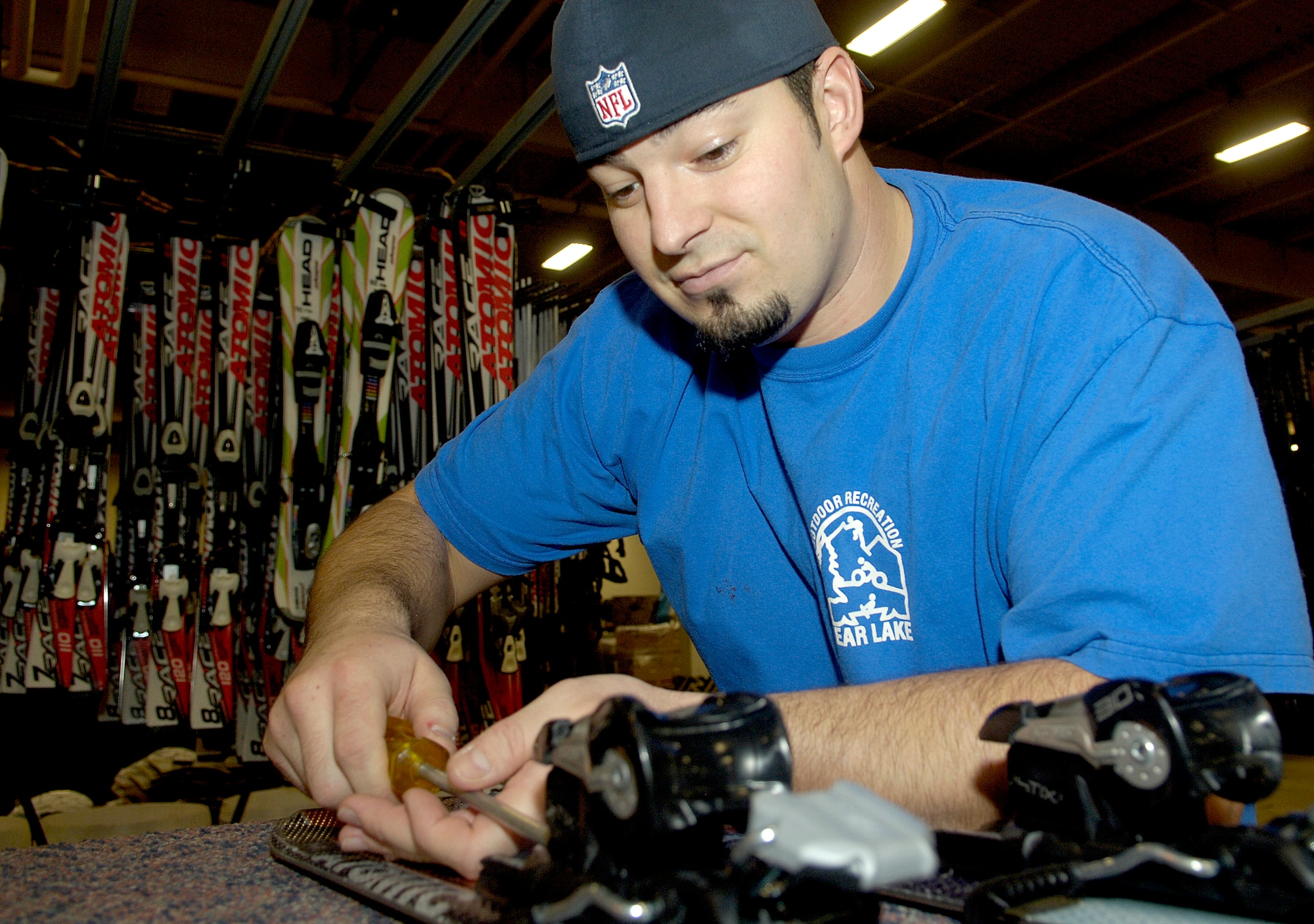 Ty McConnell, Outdoor Recreation specialist, tightens bindings onto a pair of skis Dec. 10, 2010 here. Skis and snowboards are available to rent from the center from Nov. 2 – April 1. (U.S. Air Force photo/ Senior Airman Natasha E. Stannard)