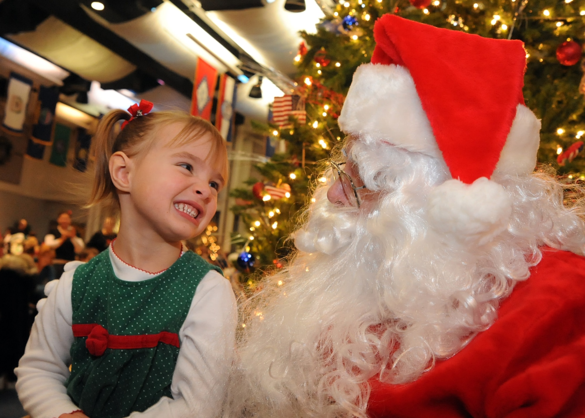 Kaylee Kollross, 3, daughter of Capt. Marcus Kollross, 344th Air Refueling Squadron pilot, speaks to Santa Claus at the Robert J. Dole Community Center Dec. 12, 2009, McConnell Air Force Base, Kan. Family members met Santa at the Dole Center and received a free photo with him.  (U.S. Air Force photo/Staff Sgt. Dallas Edwards)