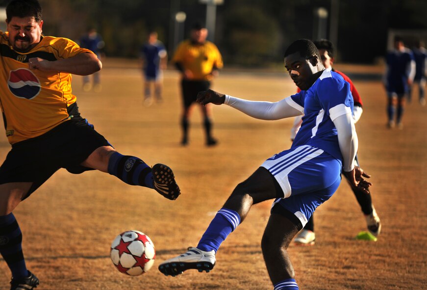 VALDOSTA, Ga.--  Paul Oforiasenso from Moody Air Force Base, Ga. attempts to make a goal while being contested by a defender during a soccer match Dec. 12. The Moody team spent most of the game on the offensive end of the field scoring four unanswered goals before the Quitman, Ga. made one by the end of the game. (U.S. Air Force photo/Airman 1st Class Joshua Green)(RELEASED)
