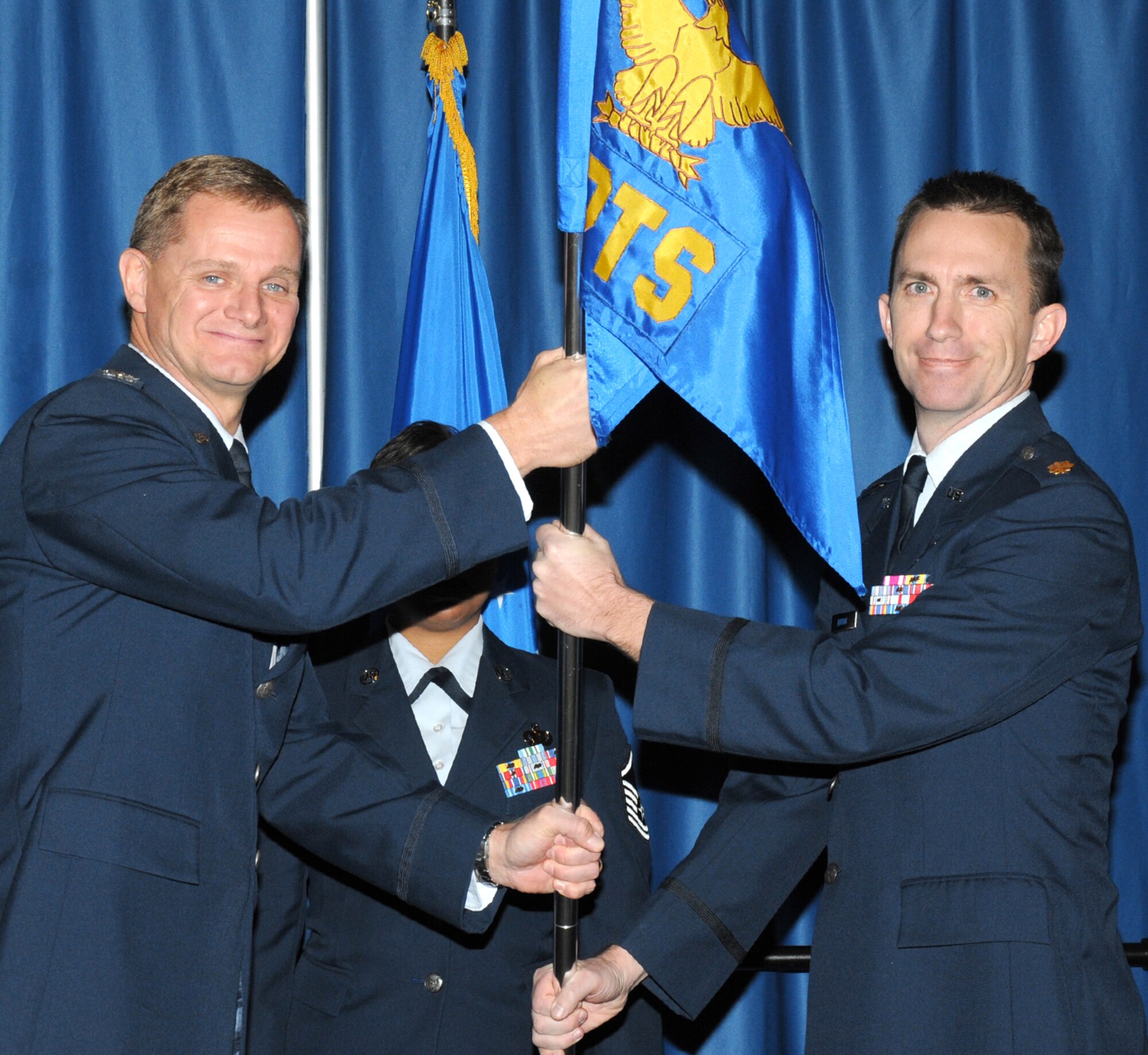 Maj. Michael Bryant, right, accepts command of the 71st Comptroller Squadron from Col. Russ Mack, 71st Flying Training Wing commander, during a change of command ceremony held Dec. 10 at the Vance Collocated Club. Major Bryant comes to Vance from the office of the assistant secretary of the Air Force, Financial Management and Comptroller. Major Bryant replaced Maj. Tina Nguyen, who was reassigned to the Naval Postgraduate School in Monterey, Calif. The 71st CPTS is responsible for planning, distributing and monitoring the 71st FTW’s $110 million annual budget, as well as providing travel, military pay and customer service for active duty, retired and reserve military members in the local area. (U.S. Air Force photo/ Terry Wasson) 