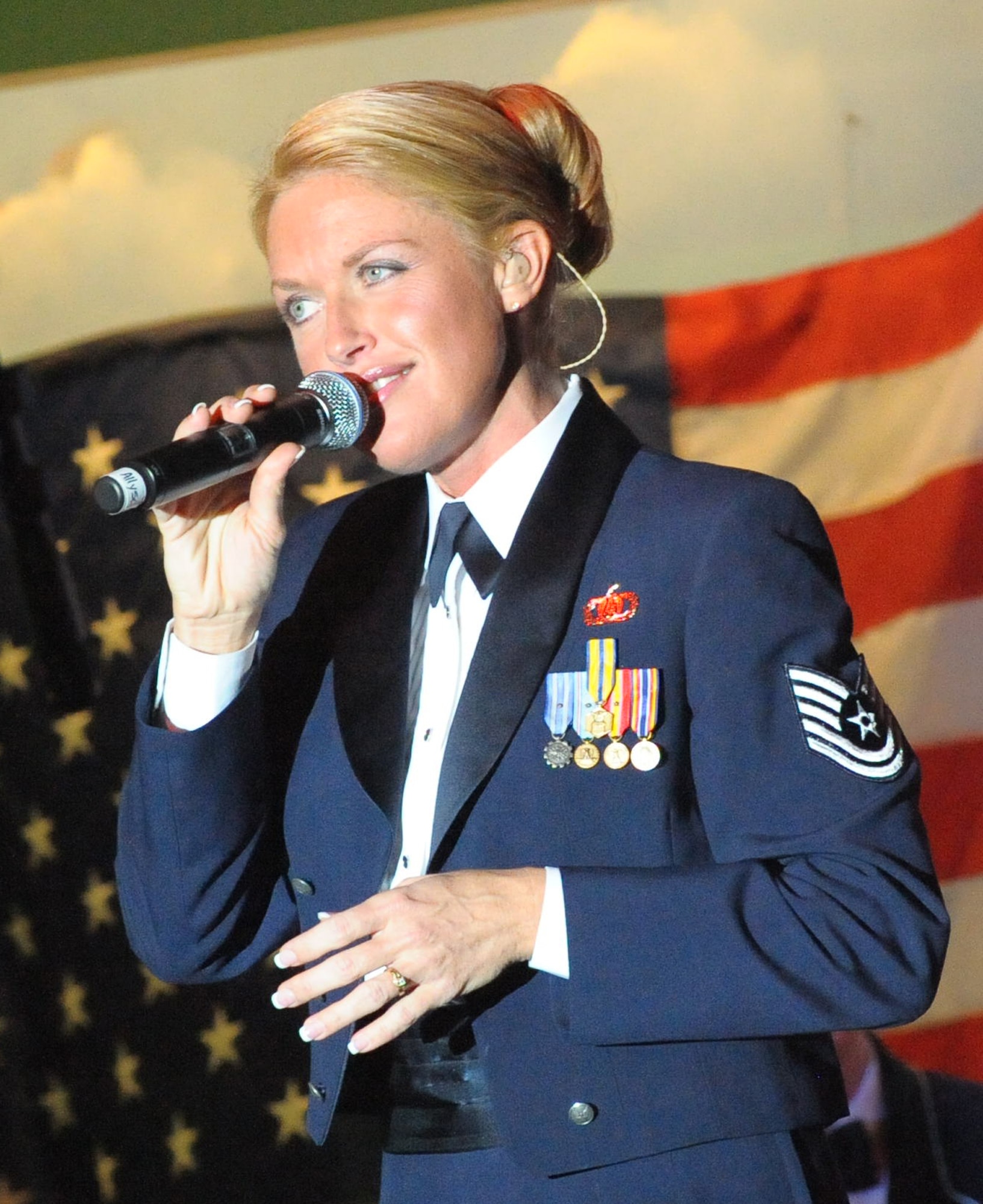 Tech Sgt. Alyson Jones, vocalist with the Band of the U.S. Air Force Reserve, performs duing the Holiday Concert at the Museum of Aviation Dec. 9, 2010. More than 800 Warner Robins community members attended the annual event. (U.S. Air Force photo/Raymond Crayton, Jr.)