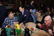 MINOT AIR FORCE BASE, N.D. -- Capt. Genieve David, Minot AFB public affairs officer, serves food to Minot senior citizens participating in the Day of Love feast here Dec. 12. The base has hosted the Day of Love since 1969, and its popularity with the base and local community has made it a long-standing tradition ever since. (U.S. Air Force photo/Airman 1st Class Aaron-Forrest Wainwright)