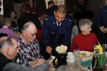 MINOT AIR FORCE BASE, N.D. -- Capt. Eddie Rubero, 5th Bomb Wing protestant chaplain, serves food to Minot senior citizens participating in the Day of Love feast here Dec. 12. The base has hosted the Day of Love since 1969, and its popularity with the base and local community has made it a long-standing tradition ever since. (U.S. Air Force photo/Airman 1st Class Aaron-Forrest Wainwright)