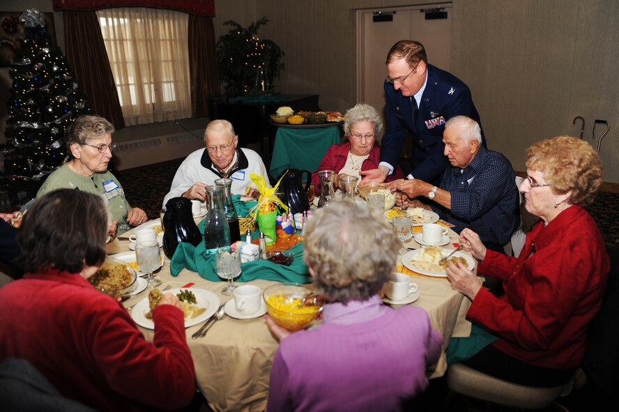 MINOT AIR FORCE BASE, N.D. -- Col. Doug Cox, 5th Bomb Wing commander, serves food to Minot senior citizens participating in the Day of Love feast here Dec. 12. The base has hosted the Day of Love since 1969, and its popularity with the base and local community has made it a long-standing tradition ever since. (U.S. Air Force photo/Airman 1st Class Aaron-Forrest Wainwright)