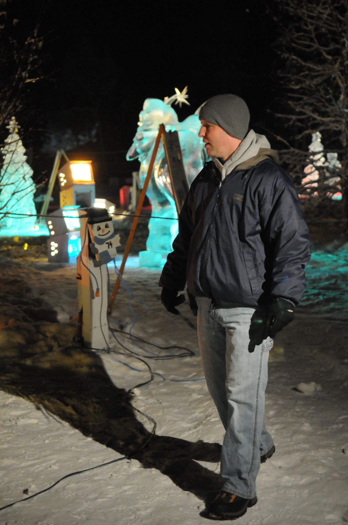 Staff Sgt. Nathan Funkhouser walks through the Christmas in Ice Park Dec. 10, 2010, North Pole, Alaska. The 354th Logistics Readiness Squadron provided 42 nights of security to ensures the sculptures remained untouched. Sergeant Funkhouser is a 354th LRS Fuels Information Manager. (U.S. Air Force photo by Airman 1st Class Janine Thibault)