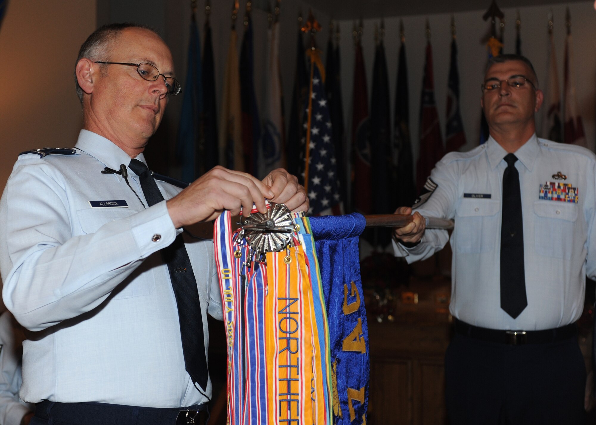DYESS AIR FORCE BASE, Texas -- Lt. Gen. Robert R. Allardice, 18th Air Force commander, presents the 317th Airlift Group their Meritorious Unit Award here, Dec. 13. Airmen contributed to 8,600 sorties, delivering 306,000 personnel and 9,900 tons of cargo in support of Operation Enduring Freedom, Operation Iraqi Freedom and Joint Task Force Horn of Africa. 317 AG support of inter-theater airlift contributed to the highest number of personnel airlifted to the entire area of responsibility while maintaining an aging fleet of C-130H aircraft to accomplish an envied 99 percent mission effectiveness rate. (U.S. Air Force photo/ Senior Airman Jenifer H. Calhoun)