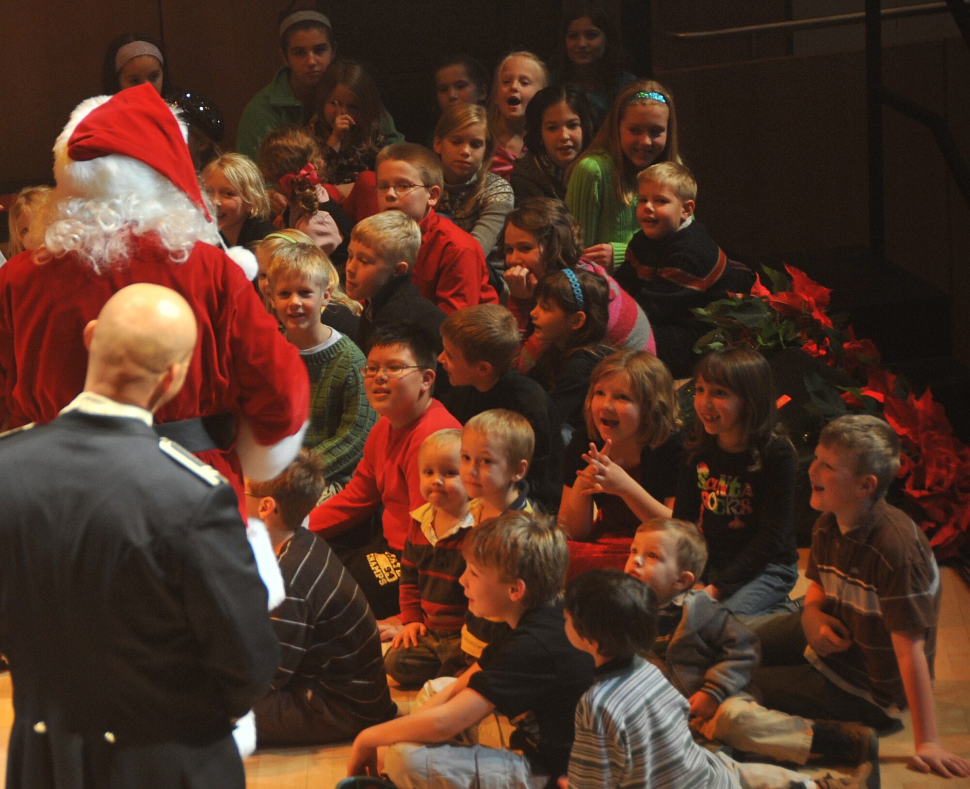 OFFUTT AIR FORCE BASE, Neb. - Children react to a visit from Santa at the annual holiday concert Dec. 8 at the Holland Performing Arts Center in downtown Omaha. The annual holiday concert is a way Team Offutt works with local businesses like the Omaha World Herald to give back to the community. U.S. Air Force Photo by Jeff W. Gates.