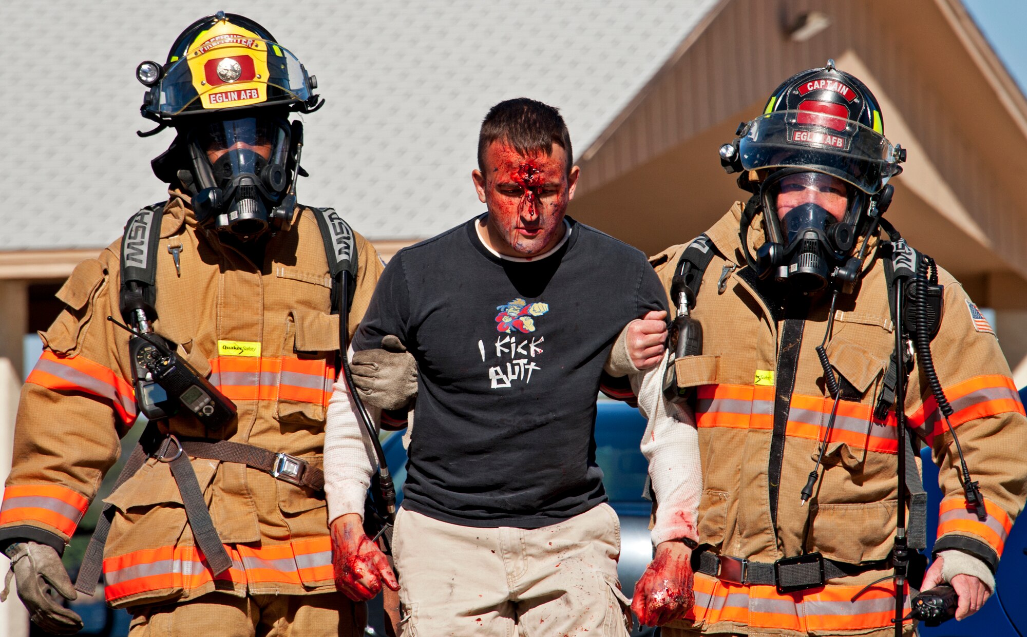 Airman 1st Class DeMichael Overstreet and Christopher Hoffman,96th Civil Engineer Squadron firefighters, helps a “victim” out of the contaminated zone at Post'l Point Dec. 1.  The base's Chemical Biological Nuclear Explosive exercise tested Eglin's first responders such as security forces and fire department as well as the medical group's emergency technicians.  96th Medical Group Airmen set up a decontamination tent to process the victims through before providing detailed medical attention.   (U.S. Air Force photo/ Samuel King)