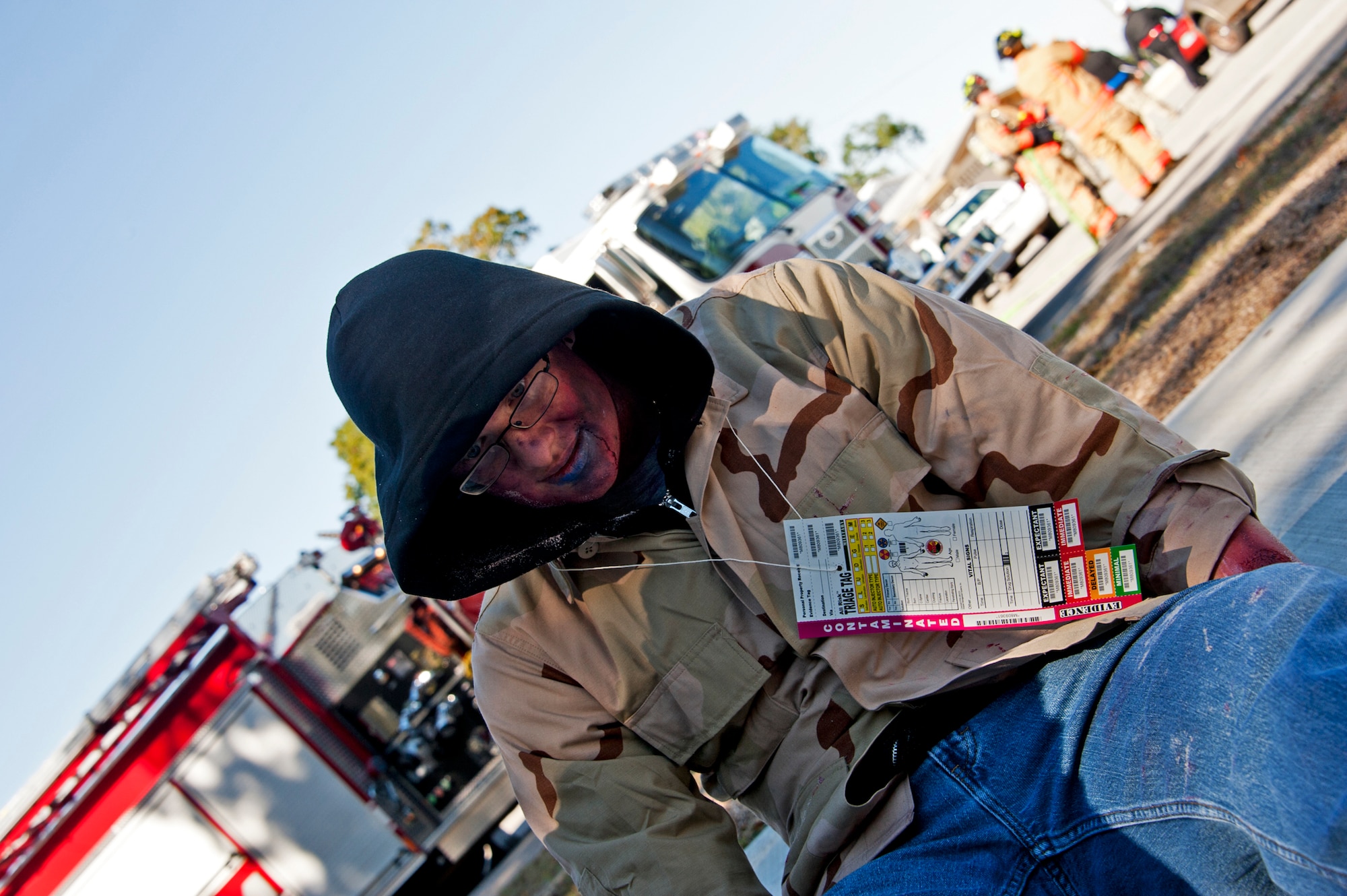 A victim waits for treatment at the on-scene triage after a simulated chlorine explosion  at Post'l Point Dec. 1 during the base's Chemical Biological Nuclear Explosive exercise.  The exercise tested Eglin's first responders such as security forces and fire department as well as the medical group's emergency technicians.  96th Medical Group Airmen set up a decontamination tent to process the victims through before providing detailed medical attention.   (U.S. Air Force photo/ Samuel King) 
