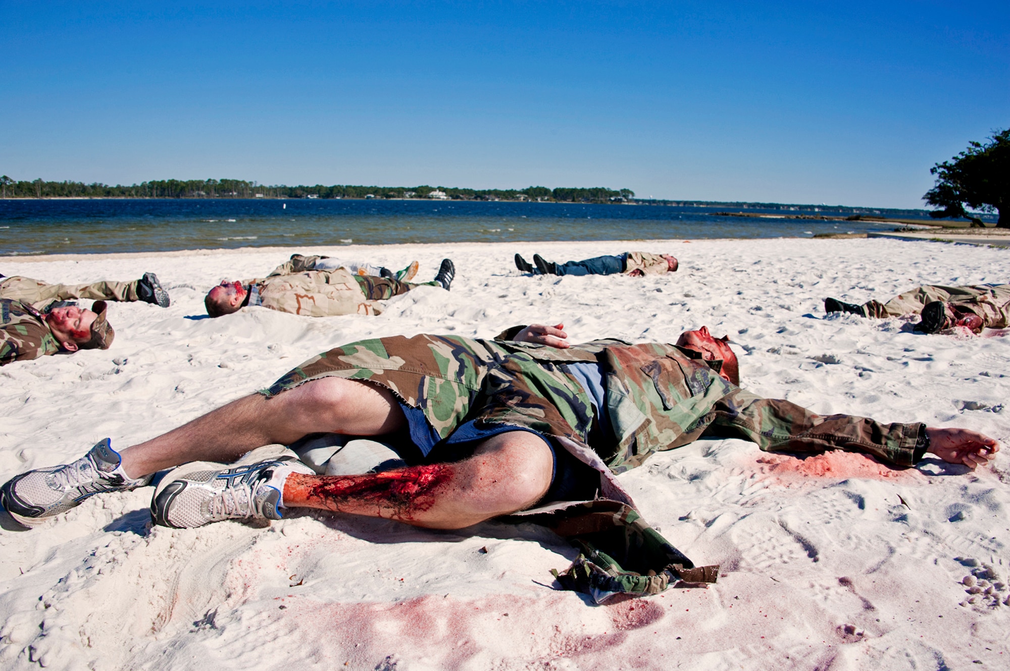 Victims of a simulated chlorine attack lay on the beach at Post'l Point Dec. 1 during the base's Chemical Biological Nuclear Explosive exercise.  The exercise tested Eglin's first responders such as security forces and fire department as well as the medical group's emergency technicians.  96th Medical Group Airmen set up a decontamination tent to process the victims through before providing detailed medical attention.   (U.S. Air Force photo/ Samuel King) 