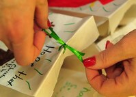 MINOT AIR FORCE BASE, N.D. -- Members of the Officer Spouses Club collect and package cookies for the annual cookie drive here Dec.9. Cookies were donated by base personnel as well as companies and families from Minot, N.D. These packages are given to Airmen residing in the dormitories as a way to spread holiday cheer. (U.S. Air Force photo/Senior Airman Michael J. Veloz)