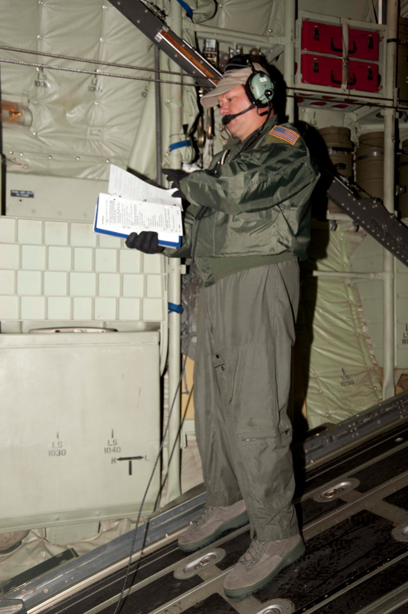 Tech. Sgt. Jeffrey Fountain, 815th Airlift Squadron loadmaster, runs his checklist in preparation for the 815th AS and 345th AS aircrew's participation in the 13th Annual Randy Oler Memorial Operation Toy Drop held Saturday, Dec. 11 at Ft. Bragg, N.C.
