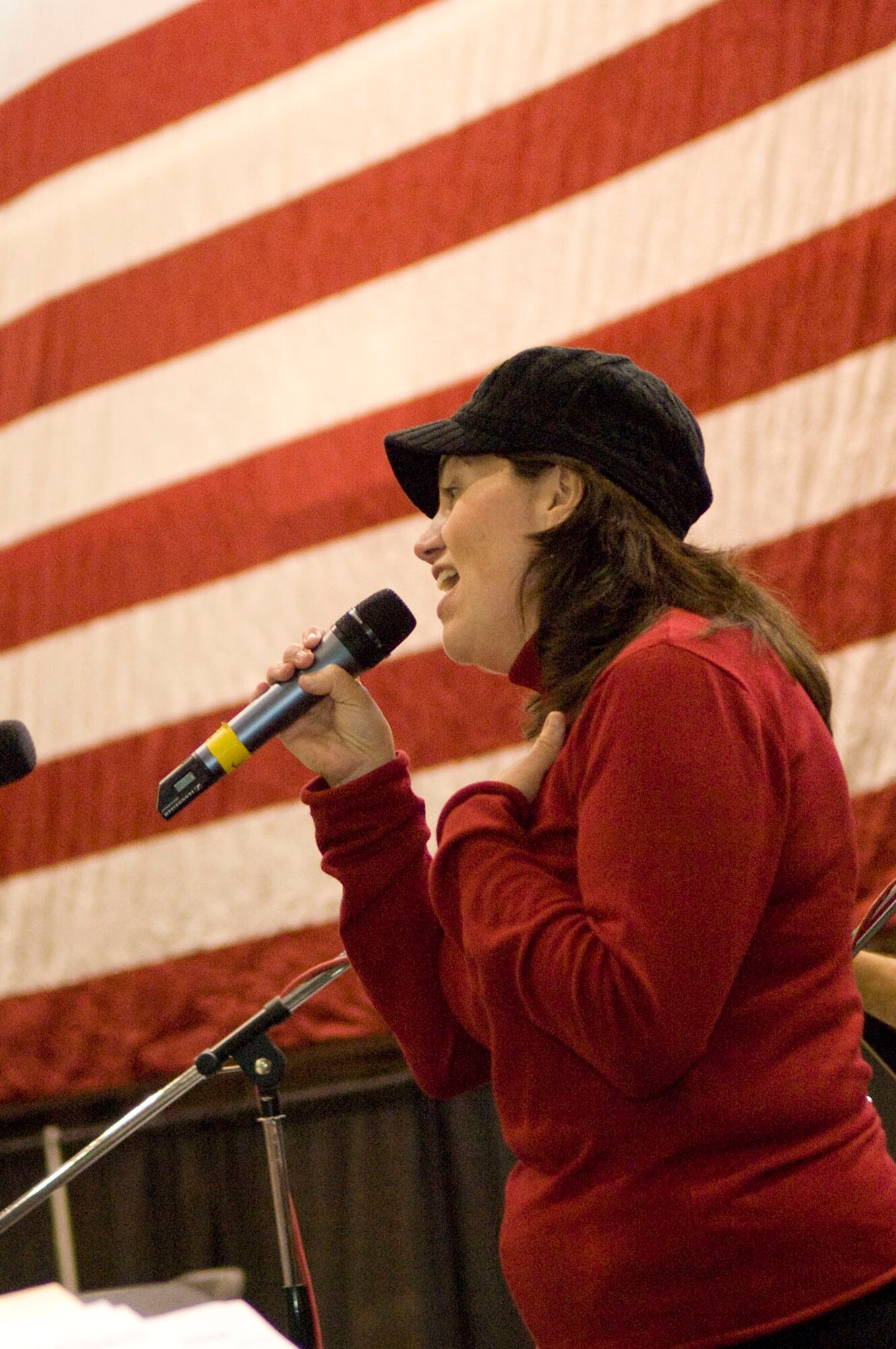 HANSCOM AIR FORCE BASE, Mass. – Amy-Jayne McCabe sings “The Rock” during Heroes Homecoming in the Aero Club Hangar on Dec. 10. McCabe wrote the song while her husband was deployed and dedicated it to the family members who have deployed loved ones. (U.S. Air Force photo by Mark Wyatt)