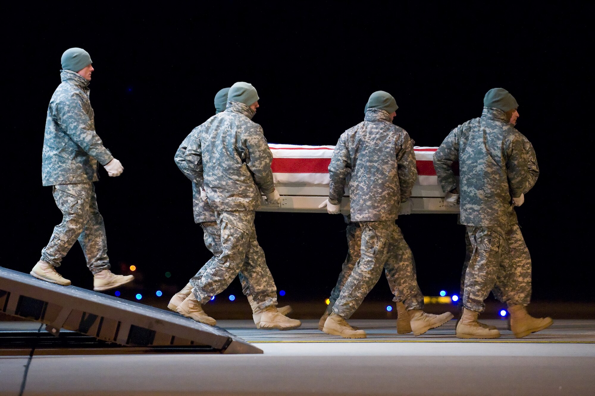 A U.S. Army carry team transfers the remains of Army Spc. Kenneth E. Necochea Jr., of San Diego, Calif., at Dover Air Force Base, Del., Dec. 13, 2010. Necochea was assigned to the 2nd Battalion, 502nd Infantry Regiment, 2nd Brigade Combat Team, 101st Airborne Division (Air Assault), Fort Campbell, Ky. (U.S. Air Force photo/Roland Balik)
