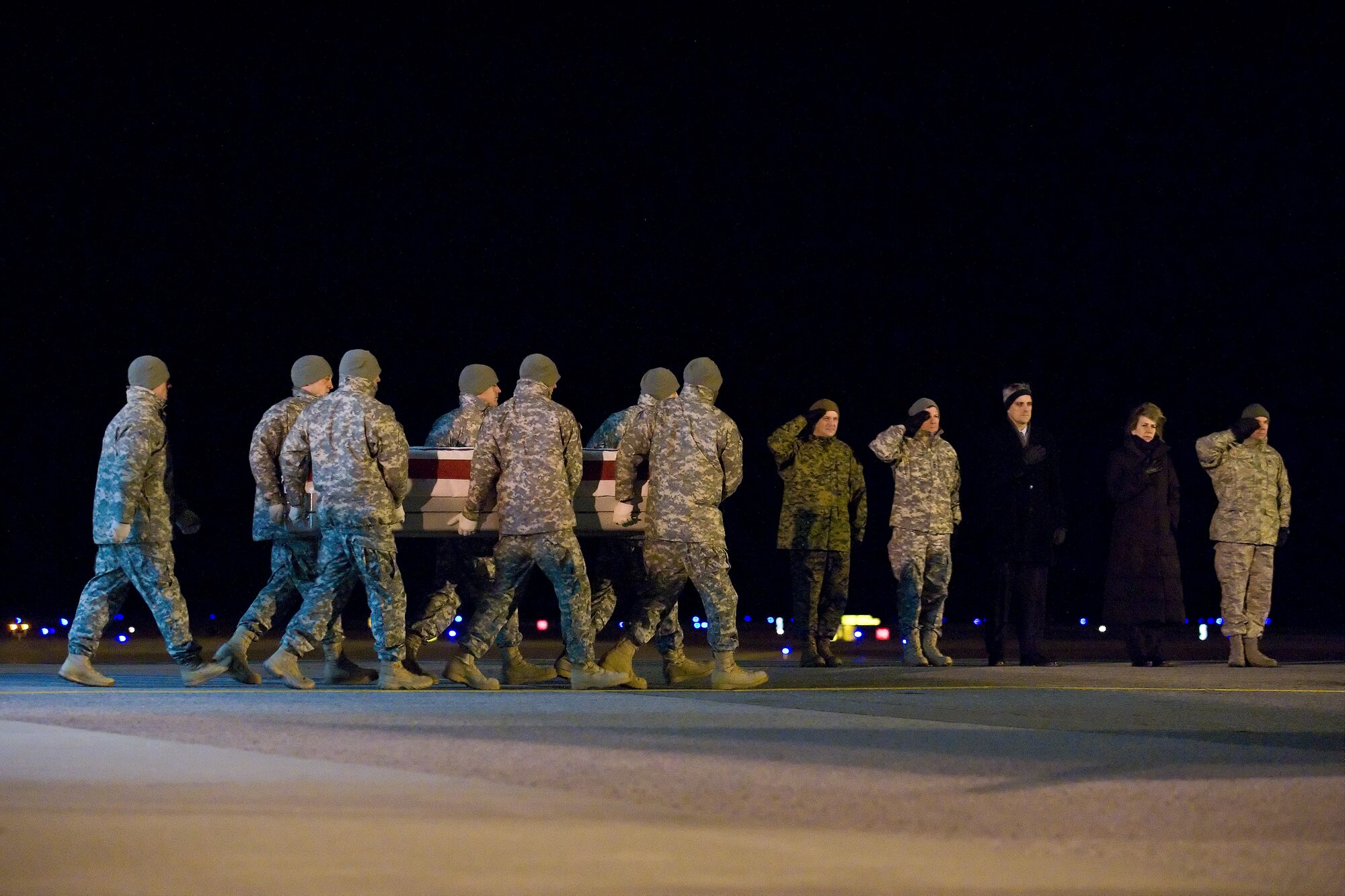 A U.S. Army carry team transfers the remains of Army Sgt. Sean M. Collins, of Ewa Beach, Hawaii, at Dover Air Force Base, Del., Dec. 13, 2010. Collins was assigned to the 2nd Battalion, 502nd Infantry Regiment, 2nd Brigade Combat Team, 101st Airborne Division (Air Assault),Fort Campbell, Ky.(U.S. Air Force photo/Roland Balik)