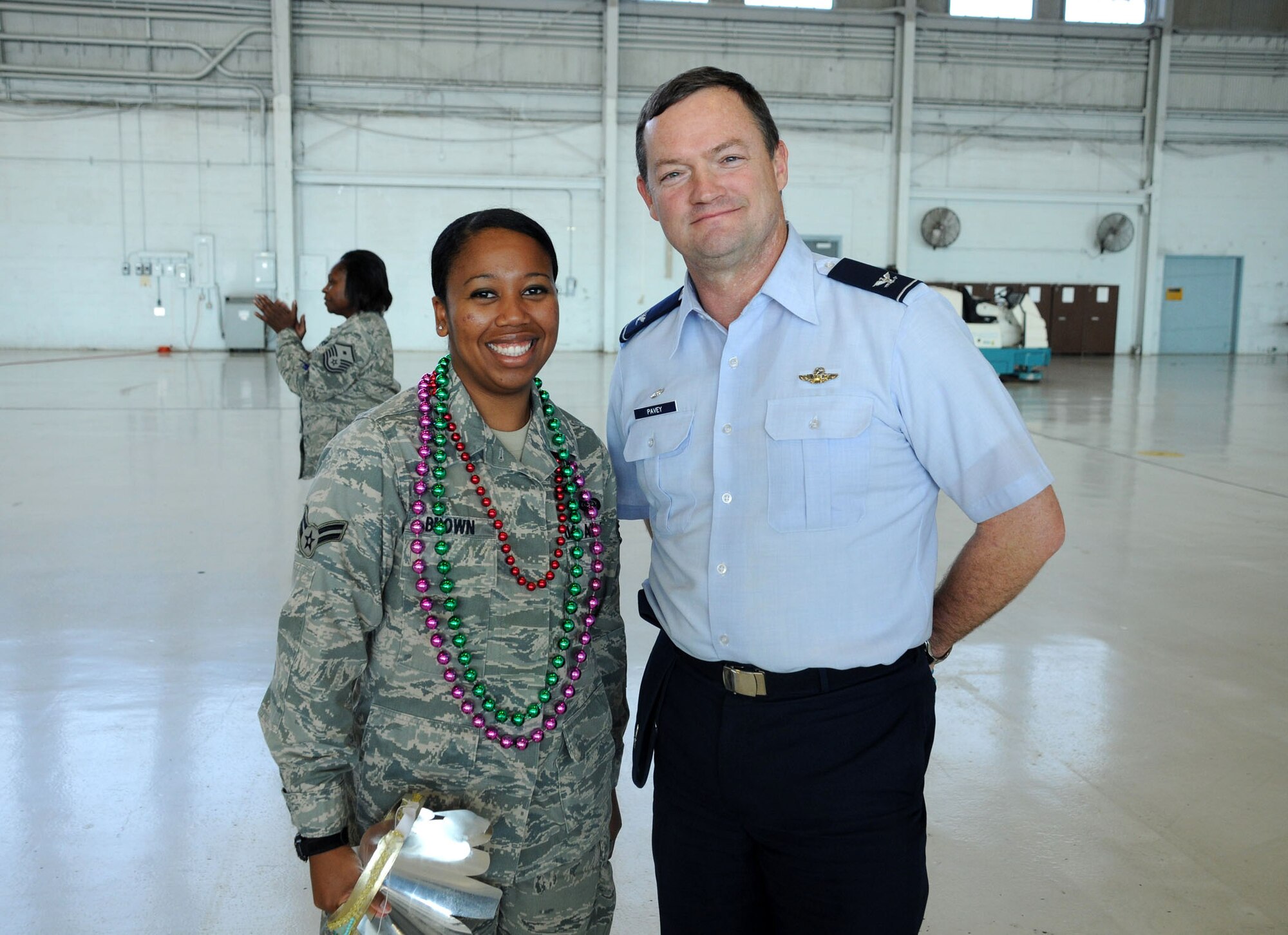 MacDill Air Force Base, Fla. -- Airman First Class Jasmine Brown, a member of the 927th's Aeromedical Evacuation Squadron, won the prize for best Mardi Gras mask at the holiday party this year. She stands beside Col. David Pavey, commander of the 927th Air Refueling Wing. (Official United States Air Force photo by Staff Sgt. Shawn C. Rhodes)