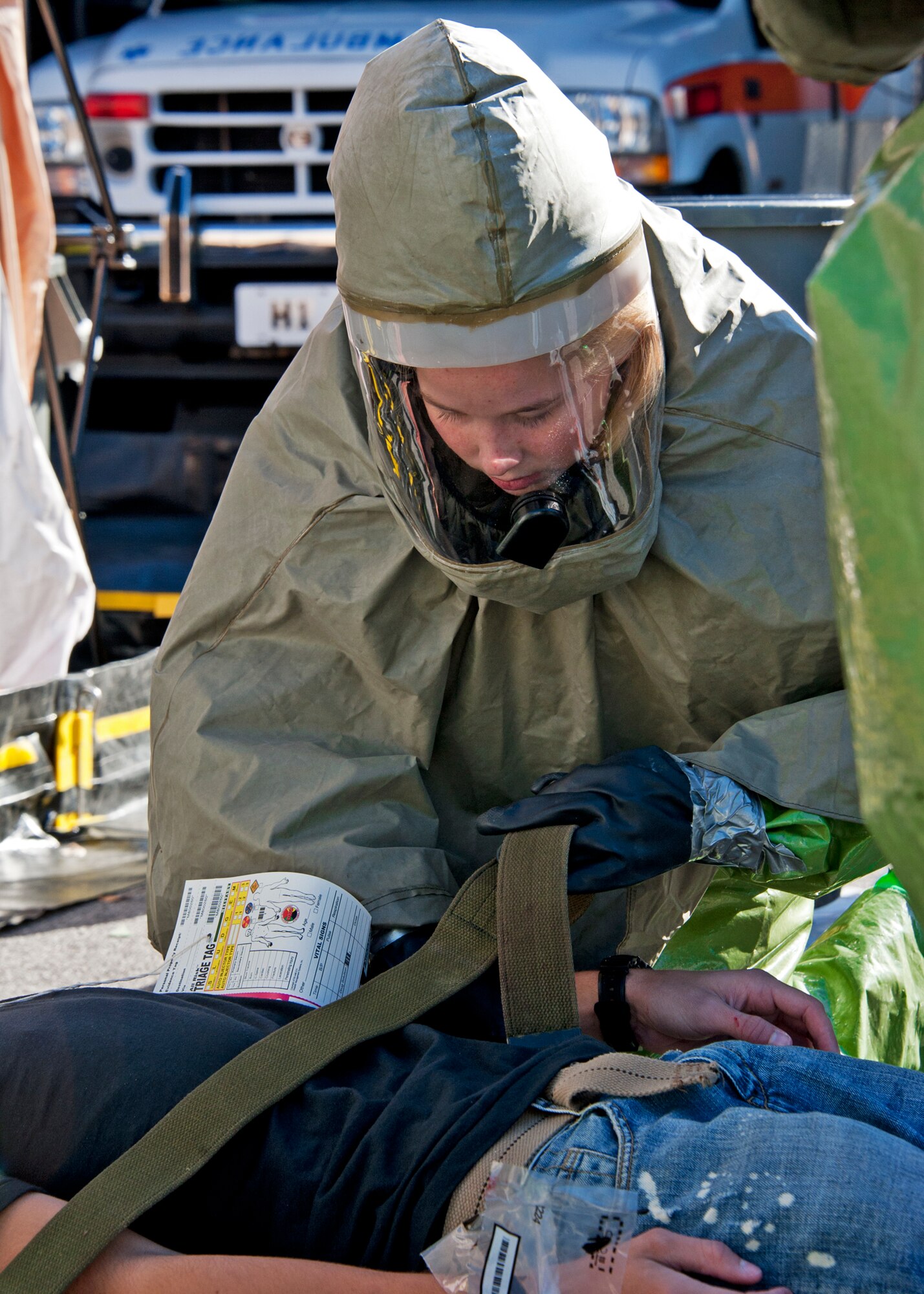 Airman 1st Class Tamaka Kuehn, 96th Medical Group Airman secures a victim prior to moving him through decontamination Dec. 1 at Eglin Air Force Base, Fla.  The base held a Chemical Biological Nuclear Explosive exercise testing first responders such as security forces and fire department as well as the medical group's emergency technicians.    96th Medical Group Airmen set up a decontamination tent to process the victims through before providing detailed medical attention.   (U.S. Air Force photo/ Samuel King) 