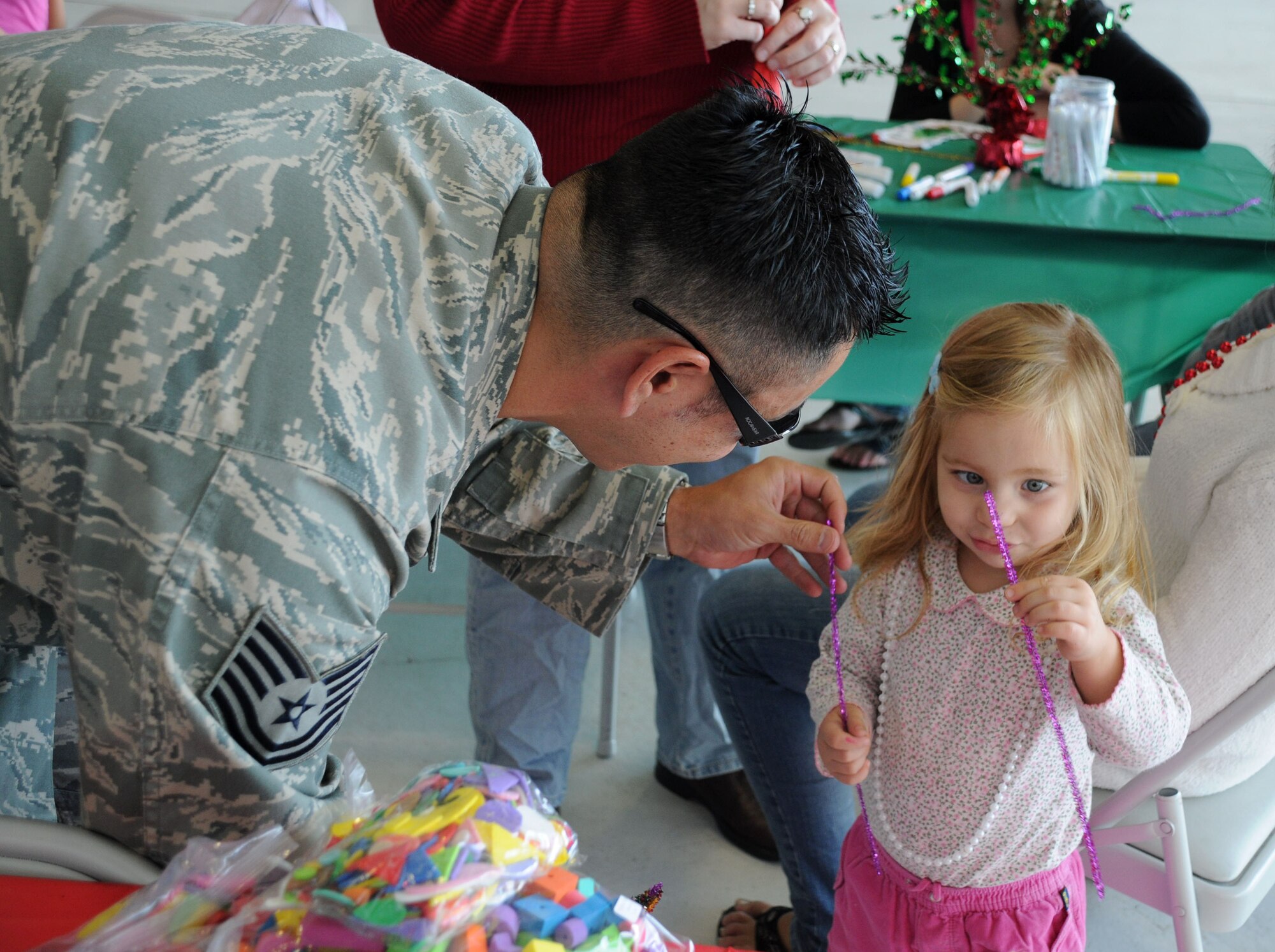 MacDill Air Force Base, Fla. --  Technical Sergeant Anthony Tobin understands the importance of family.  The family readiness center, where Tobin works, played a part in organizing the 927th Air Refueling Wing's holiday party this year.  Tobin assisted Molly Jordan, 2 with some of the children's activities at the party. (Official United States Air Force photo by Staff Sgt. Shawn C. Rhodes)