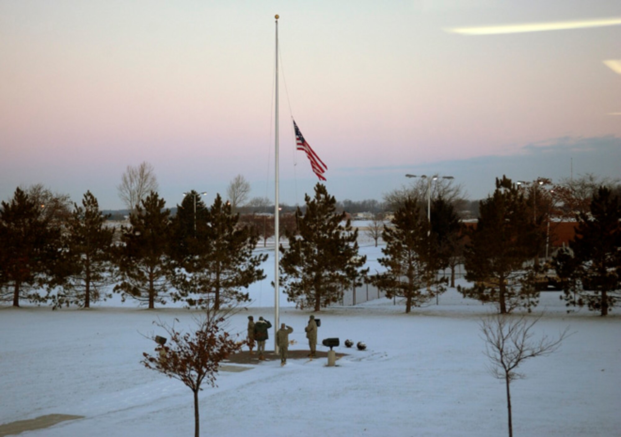 GRISSOM AIR RESERVE BASE, Ind., -- Winter arrived at Grissom ARB in the form of snow, bone-chilling temperatures and gusty winds.  However, the weather did not stop the dedicated men and women of the 434th Air Refueling Wing from performing their duties, including raising the flag at the base flag pole.   (U.S. Air Force photo)                        