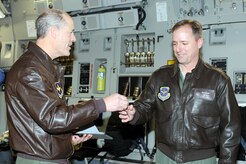 Air Force Lt. Gen. Allen G. Peck hands the keys to Col. John Wood after delivering the newest C-17A to the 437th Airlift Wing, Charleston, S.C., Dec. 9, 2010. The arrival of the aircraft brings the total number of C-17s assigned to the wing to 58. General Peck is the Air University commander and Colonel Wood is the 437 AW commander. (U.S. Air Force photo/Staff Sgt. Marie Brown)