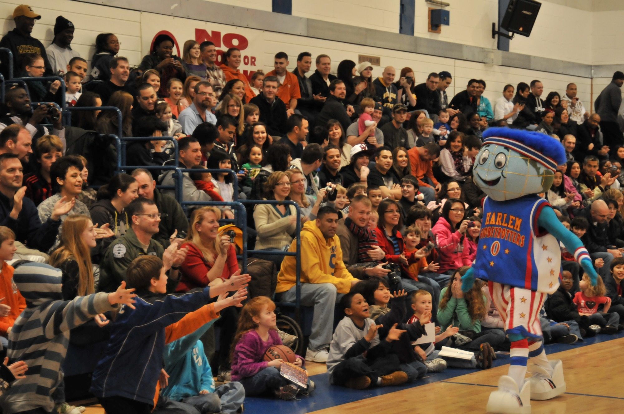 ROYAL AIR FORCE LAKENHEATH, England – Children cheer for Globie, mascot of the Harlem Globetrotters, Dec. 12 in the Sports & Fitness Center. Globie warmed up the crowd before the start of the Globetrotter’s game against their perennial rivals, the Washington Generals. (U.S. Air Force photo/Senior Airman David Dobrydney)