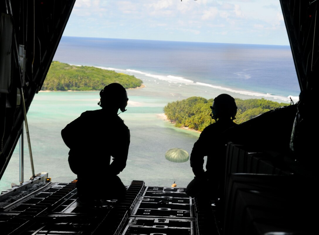Airmen from the 36th Airlift Squadron, Yokota Air Base, Japan, lookout upon the Islands of Micronesia during Operation Christmas Drop, Dec. 14. Operation Christmas Drop is the Air Force?s longest-running humanitarian which began in 1952. Airmen today continue the tradition delivering supplies to remote islands of the Commonwealth of the Northern Marianas Islands, Yap, Palau, Chuuk and Pohnpei. (U.S. Air Force photo/ Senior Airman Nichelle Anderson)
