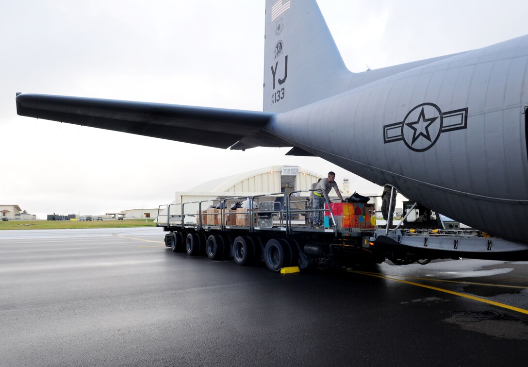 Airmen from the 36th Airlift Squadron, Yokota Air Base, Japan, load boxes of donated goods worth more than $93,000 onto a C-130 Hercules prior to take-off from Andersen Air Force Base, Guam, during Operation Christmas Drop Dec. 14. This year more than 60 boxes will be dropped to 55 Island weighing in at more than 20,000 pounds. Operation Christmas Drop is the Air Force?s longest-running humanitarian which began in 1952. Airmen today continue the tradition delivering supplies to remote islands of the Commonwealth of the Northern Marianas Islands, Yap, Palau, Chuuk and Pohnpei. (U.S. Air Force photo/ Senior Airman Nichelle Anderson)  