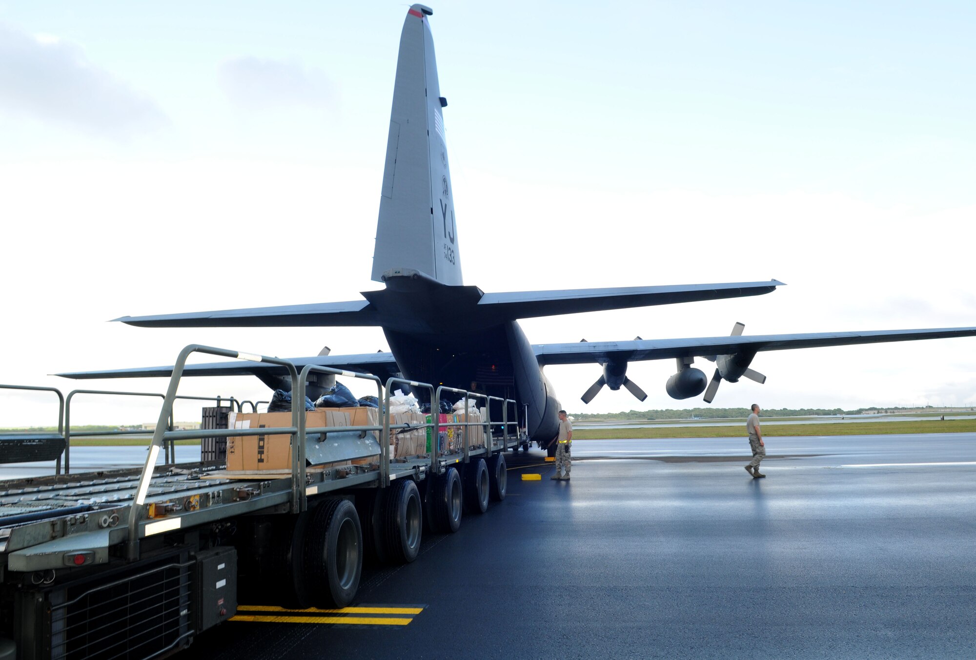 Airmen from the 36th Airlift Squadron, Yokota Air Base, Japan, load boxes of donated goods worth more than $93,000 onto a C-130 Hercules prior to take-off from Andersen Air Force Base, Guam, during Operation Christmas Drop Dec. 14. This year more than 60 boxes will be dropped to 55 Island weighing in at more than 20,000 pounds. Operation Christmas Drop is the Air Force?s longest-running humanitarian which began in 1952. Airmen today continue the tradition delivering supplies to remote islands of the Commonwealth of the Northern Marianas Islands, Yap, Palau, Chuuk and Pohnpei. (U.S. Air Force photo/ Senior Airman Nichelle Anderson)  