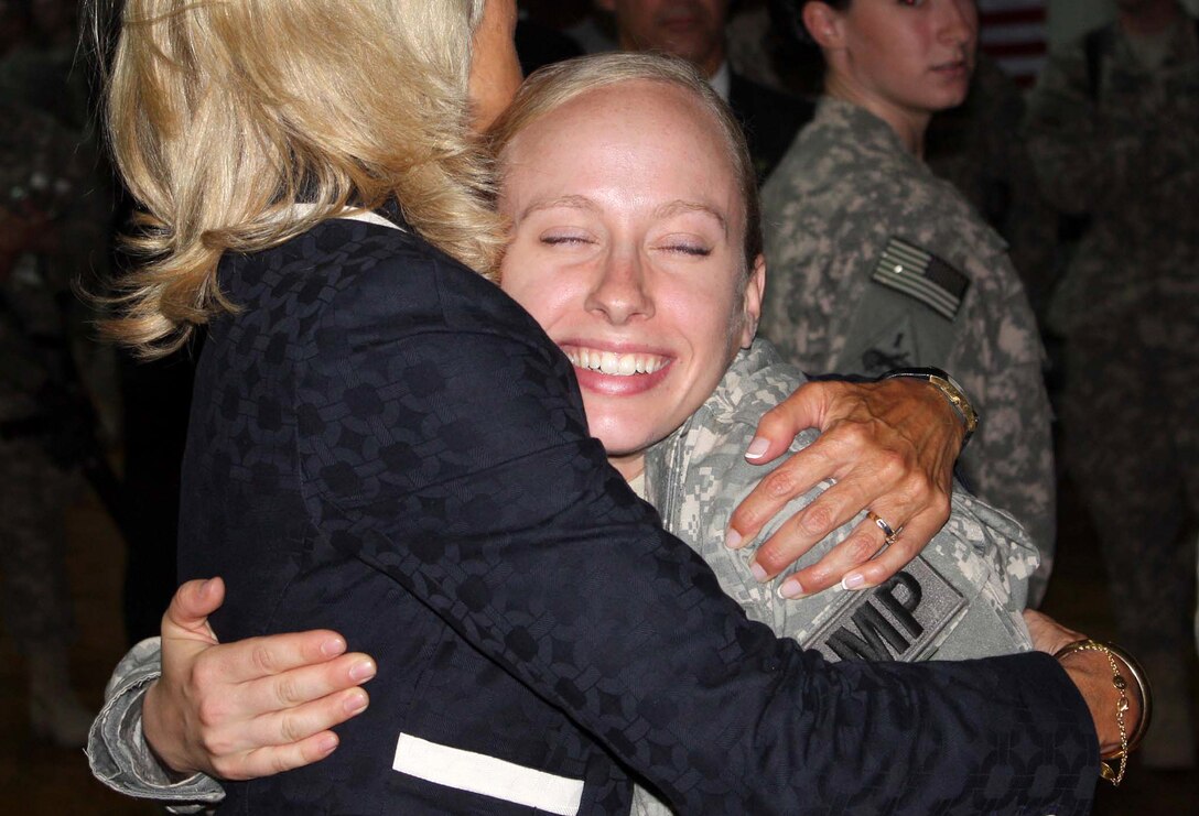 A soldier beams as she hugs Dr. Jill Biden, wife of Vice President Joe Biden, at a sports facility on Camp Victory, Iraq, July 4, 2010. DoD photo by Elaine Wilson 