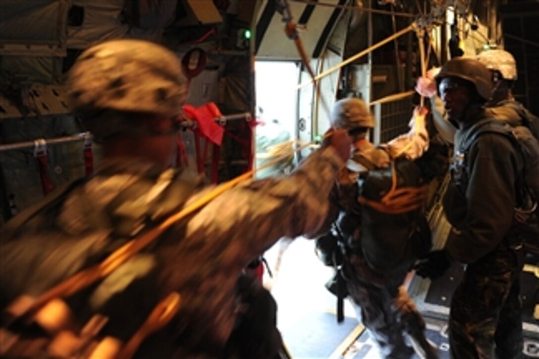 U.S. Army soldiers from the 82nd Airborne Division jump from a U.S. Air Force C-130 Hercules aircraft during the 13th annual Randy Oler Memorial Operation Toy Drop at Fort Bragg, N.C., on Dec. 11, 2010.  The event, known informally as Operation Toy Drop, gives paratroopers who donate toys for children in the region a chance to earn foreign jump wings from jumpmasters from around the world.  