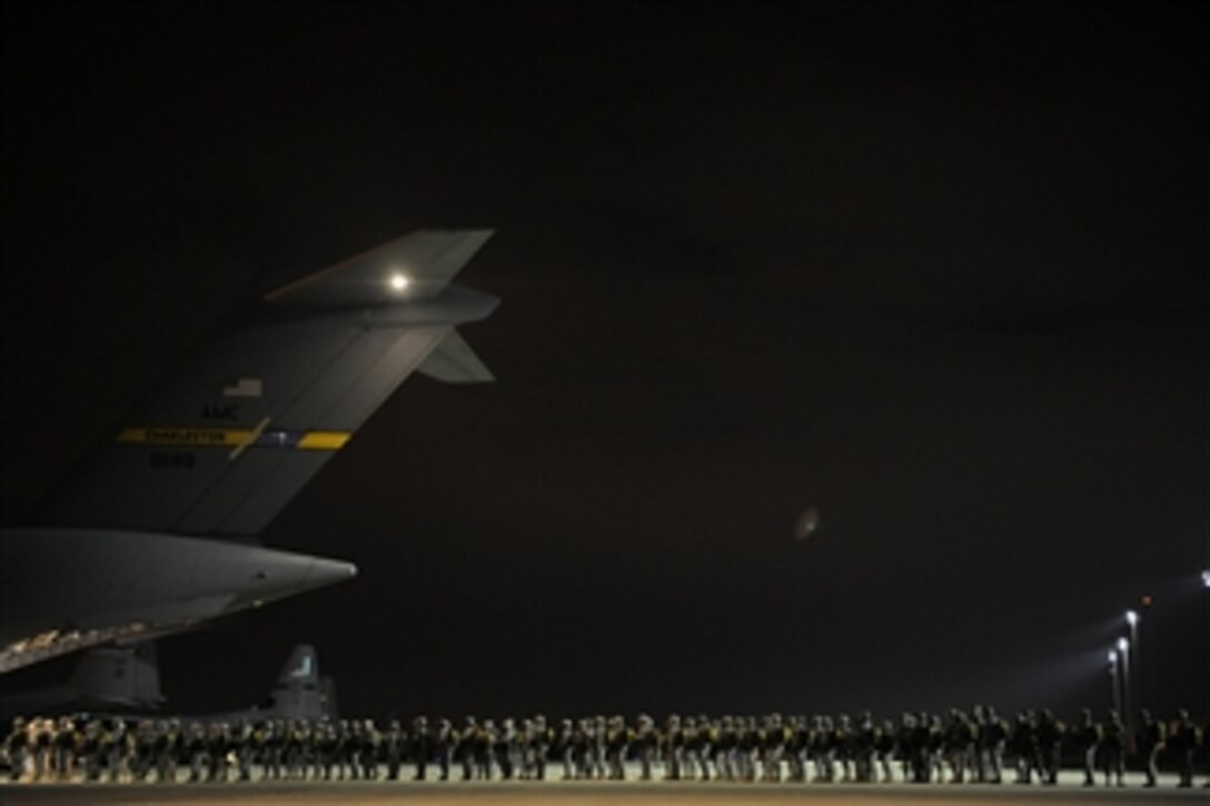 U.S. Army paratroopers and allied jumpmasters board a U.S. Air Force C-17 Globemaster III aircraft at Pope Air Force Base in North Carolina during the 13th annual Randy Oler Memorial Operation Toy Drop on Dec. 11, 2010.  The event, known informally as Operation Toy Drop, gives paratroopers who donate toys for children in the region a chance to earn foreign jump wings from jumpmasters from around the world.  
