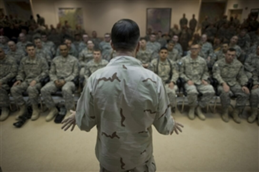 Chairman of the Joint Chiefs of Staff Adm. Mike Mullen, U.S. Navy, addresses soldiers assigned to the 1st Armored Division in Baghdad, Iraq, on Dec. 13, 2010.  Mullen and his wife Deborah are hosting the holiday tour featuring Robin Williams, Lewis Black, Kathleen Madigan, Tour de France champion Lance Armstrong and country music artist Kix Brooks of Brooks and Dunn touring the Central Command area of responsibility.  