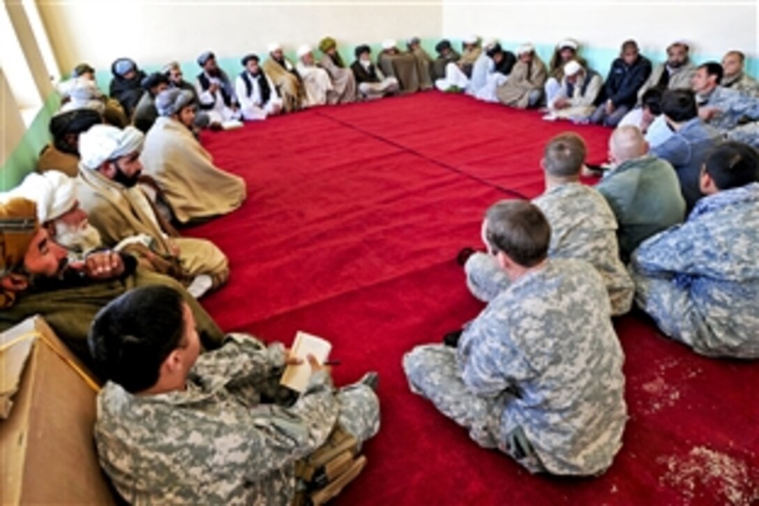 U.S. and Polish military members meet with the provincal council during a shura in the district center of Deh Yak in Afghanistan's Ghazni province, Dec. 11, 2010. The soldiers are assigned to from Forward Operating Bases Ghazni.