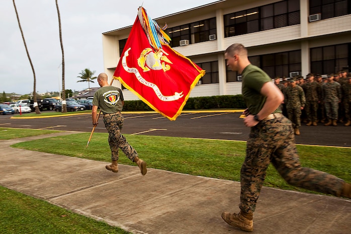 1st Lt. Gregory Veteto, executive officer, Company C, 1st Battalion, 3rd Marine Regiment, and 2nd Lt. Ian Merry, platoon commander, Company C, 1/3, run with the 3rd Marine Regiment battle colors to begin the Fallen Heroes Run on Marine Corps Base Hawaii, Dec. 14, 2010. Since 2004, 116 Marines and sailors from 3rd Marine Regiment have been killed during operations in Afghanistan and Iraq. On Dec. 14 and 15, teams of at least two Marines or sailors in combat boots and camouflage trousers ran a 2-mile evolution 116 times — one for each fallen hero. The route took them from the 3rd Marine Regiment headquarters building to the Pacific War Memorial here and back.