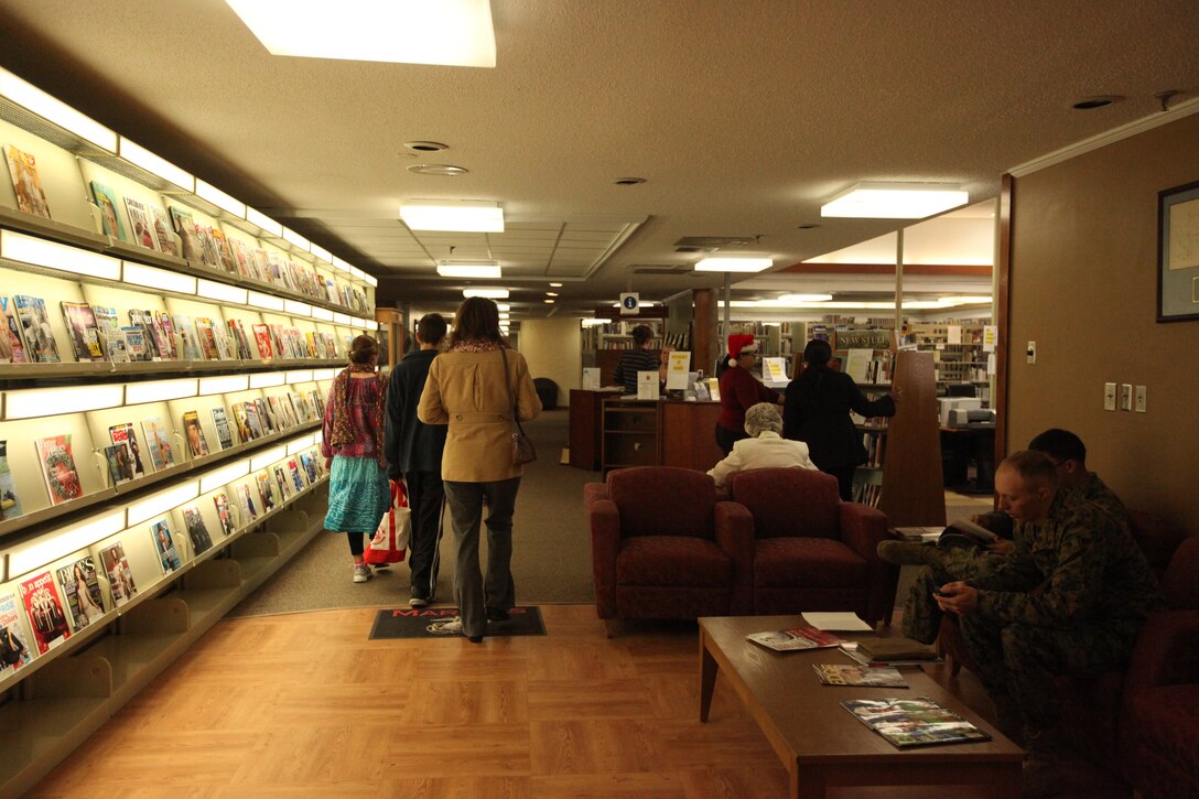 MARINE CORPS BASE CAMP LEJEUNE, N.C. - Service members and families go into the Harriet B. Smith Library, Marine Corps Community Services aboard Marine Corps Base Camp Lejeune, to look at magazines, books, movies and games, Dec. 15. The library is full of books, movies, cassette stories, games and computers all at the service member's finger tips.