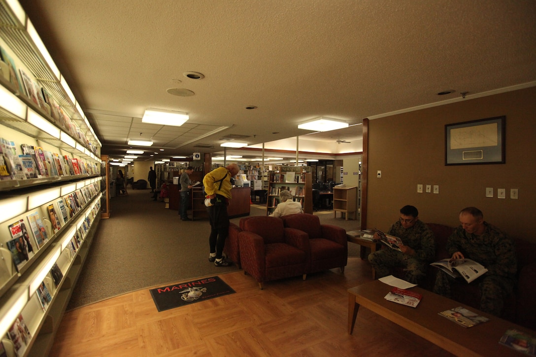 MARINE CORPS BASE CAMP LEJEUNE, N.C. - Service members look through magazines at the Harriet B. Smith Library, Marine Corps Community Services aboard Marine Corps Base Camp Lejeune, Dec. 15. The library is full of books, movies, cassette stories, games and computers all at the service member's finger tips.