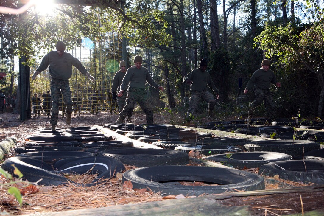 Master Sgt. Lorenzo Merced, communications chief at Marine Forces Command, Gunnery Sgt. James Wells, communications chief at MCTAG, Sgt. Michael Tabb, adjutant chief, Staff Sgt. Daniel Lowe, maintenance chief MARFORCOM and Cpl. Adio Jackman, a communications specialist with MARFORCOM, high stepped through some of the obstacle at the course, Wednesday. Their team placed fourth in the overall competition.