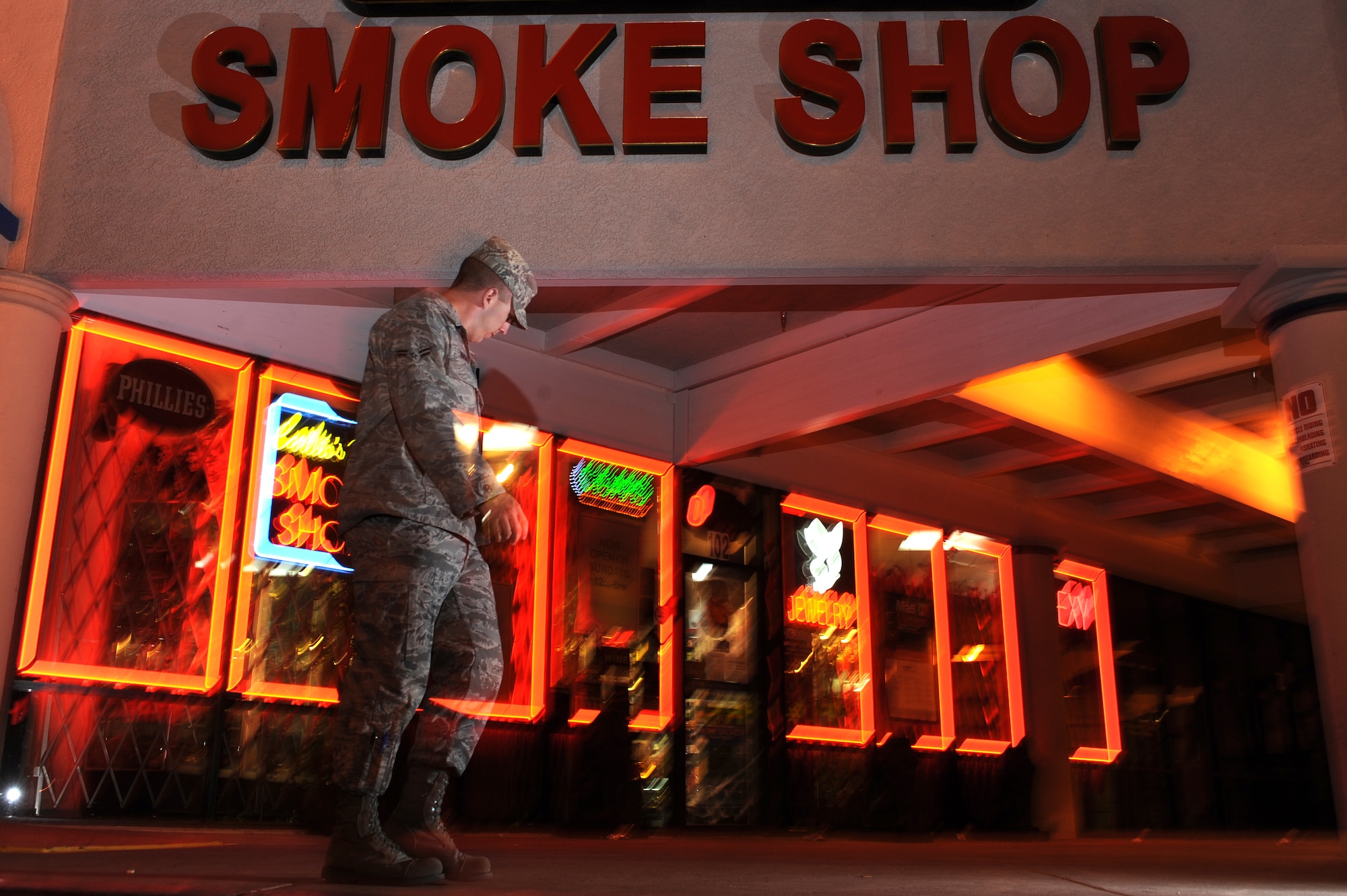 LAS VEGAS -- An Airman leaves a smoke shop near Nellis Air Force Base, Nev. Spice and other mood-altering substances are banned by the Air Force, but were legal to sell in the civilian community until Nov. 24, when the Drug Enforcement Administration used its emergency powers to ban Spice and other products that mimic the effects of marijuana. (U.S. Air Force photo illustration by Tech. Sgt. Michael R. Holzworth)