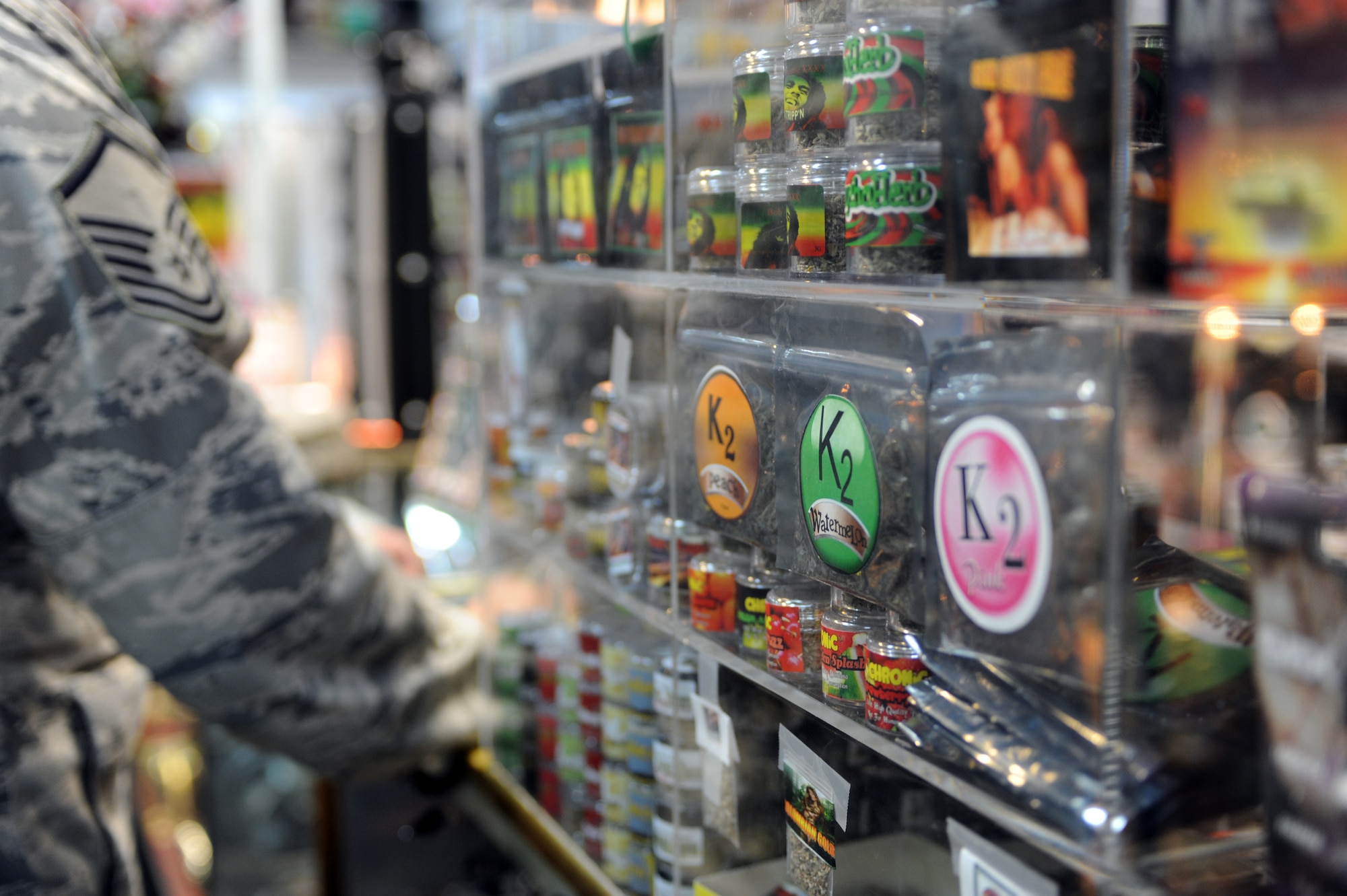 LAS VEGAS -- An Airman passes a spice display in a local smoke shop prior to a Nov. 24 ban on the substance by the Drug Enforcement Agency. Spice and other mood-altering substances are banned by the Air Force, but were legal to sell in the civilian community until the DEA used its emergency powers to implement a one-year ban of the substance. (U.S. Air Force photo illustration by Tech. Sgt. Michael R. Holzworth) 
