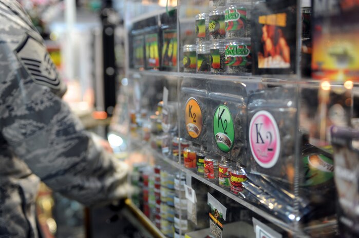 LAS VEGAS -- An Airman passes a spice display in a local smoke shop prior to a Nov. 24 ban on the substance by the Drug Enforcement Agency. Spice and other mood-altering substances are banned by the Air Force, but were legal to sell in the civilian community until the DEA used its emergency powers to implement a one-year ban of the substance. (U.S. Air Force photo illustration by Tech. Sgt. Michael R. Holzworth) 
