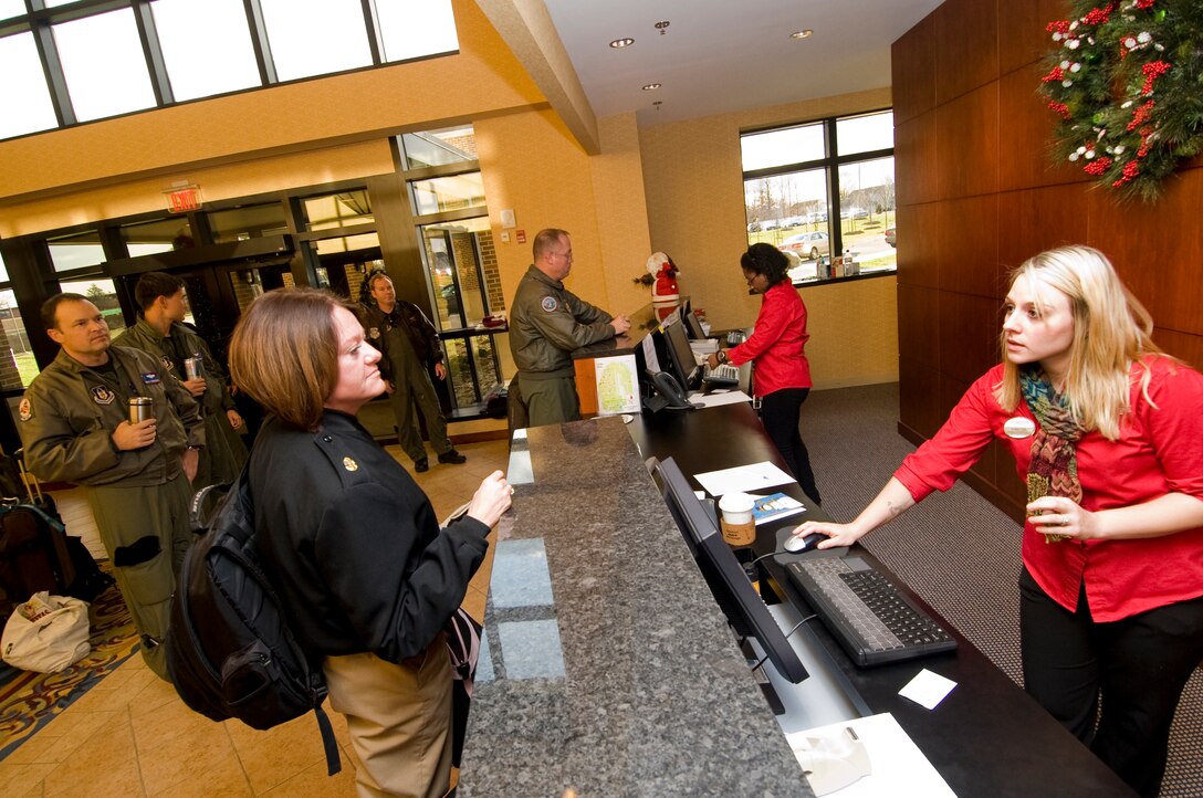 Navy Chief Petty Officer Rebecca Rein, Navy Recruiting Command Richmond, left, is checked out of the Presidential Inn by Fawn Lipe, guest service representative, Dec. 14. (U.S. Air Force photo/Bobby Jones) 